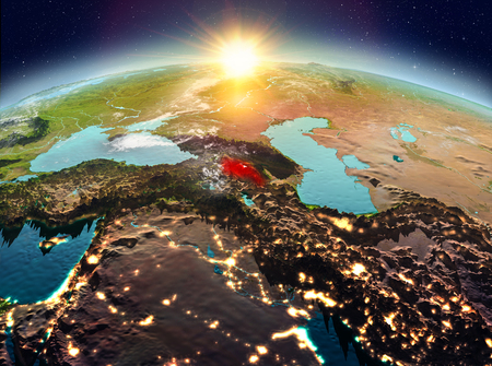Satellite view of Armenia highlighted in red on planet Earth with clouds during sunrise. 3D illustration.の写真素材