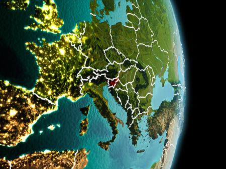 Satellite morning view of Slovenia highlighted in red on planet Earth with visible border lines and city lights. 3D illustration.の写真素材