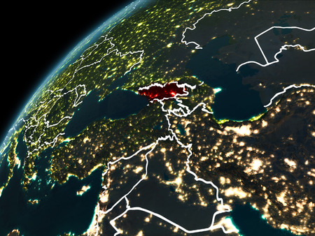 Georgia in red on planet Earth at night with visible borderlines and city lights. 3D illustration.の写真素材