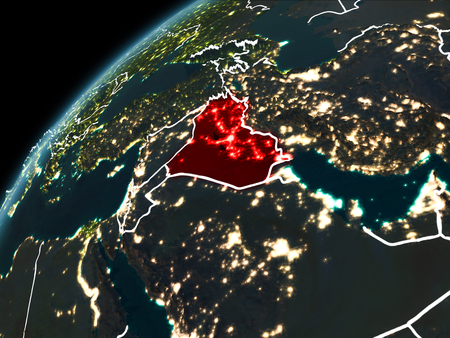 Iraq in red on planet Earth at night with visible borderlines and city lights. 3D illustration.の写真素材