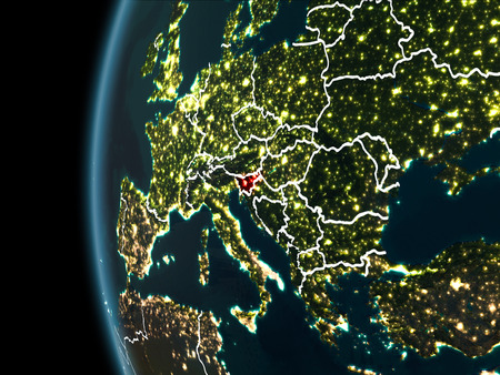 Orbit view of Slovenia highlighted in red with visible borderlines and city lights on planet Earth at night. 3D illustration.の写真素材