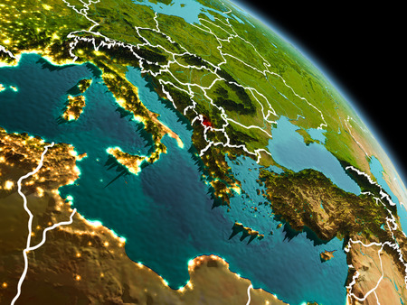 Early morning view of Kosovo highlighted in red on planet Earth with visible border lines and city lights. 3D illustration.の写真素材