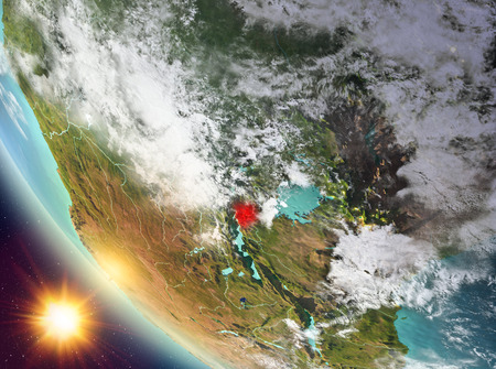 Burundi during sunset highlighted in red on planet Earth with clouds. 3D illustration.の写真素材