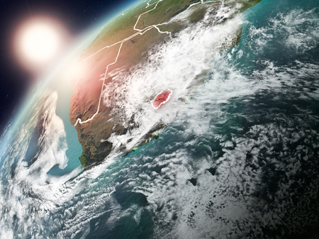Lesotho during sunset highlighted in red on planet Earth with clouds and visible country borders. 3D illustration.の写真素材