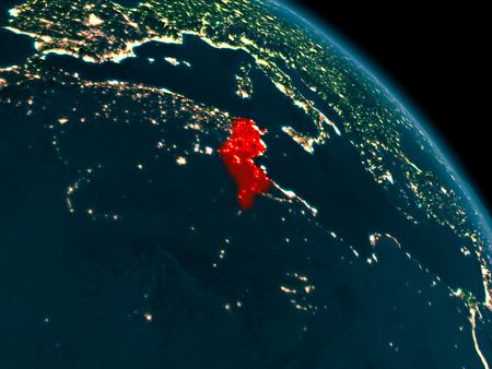 Orbit view of Tunisia at night highlighted in red on planet Earth with highly detailed surface textures. 3D illustration.の写真素材