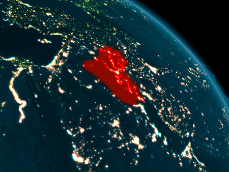 Orbit view of Iraq at night highlighted in red on planet Earth with highly detailed surface textures. 3D illustration.の写真素材