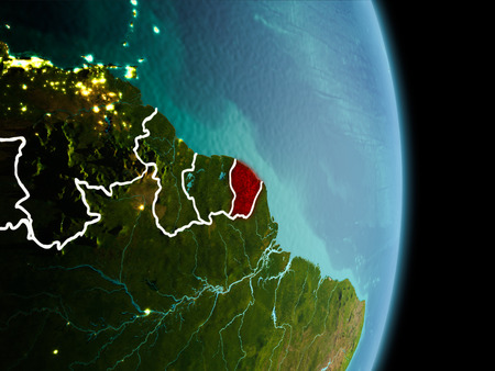 Satellite morning view of French Guiana highlighted in red on planet Earth with visible border lines and city lights. 3D illustration.の写真素材