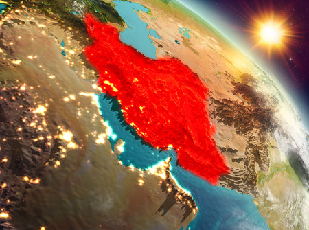 Sunrise above Iran highlighted in red on model of planet Earth in space. 3D illustration.の写真素材