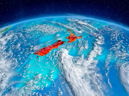 Orbit view of New Zealand highlighted in red on planet Earth with highly detailed surface textures. 3D illustration.の写真素材