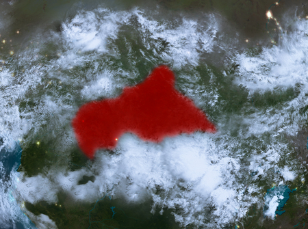 Country of Central Africa in red on planet Earth with clouds at night. 3D illustration.の写真素材