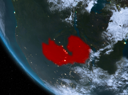 Zambia at night highlighted in red on planet Earth with clouds. 3D illustration.の写真素材