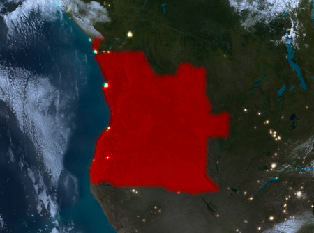 Country of Angola in red on planet Earth with clouds at night. 3D illustration.の写真素材
