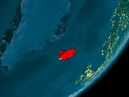 Night view of Iceland highlighted in red on planet Earth with atmosphere. 3D illustration.の写真素材