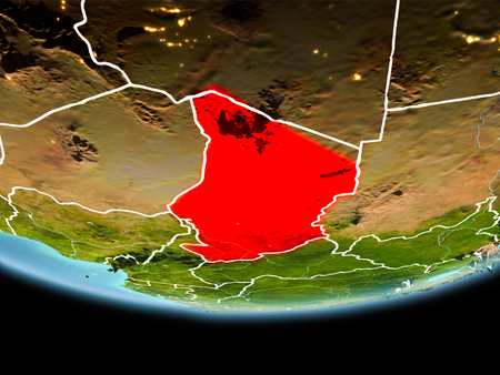 Country of Chad in red on planet Earth in the evening with visible border lines and city lights. 3D illustration.の写真素材
