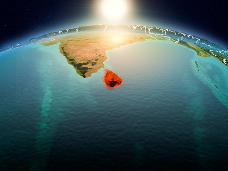 Sunrise above Sri Lanka highlighted in red on model of planet Earth in space with visible country borders. 3D illustration.の写真素材