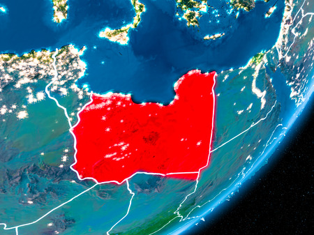 Libya in red on planet Earth at night with visible borderlines and city lights. 3D illustration.の写真素材