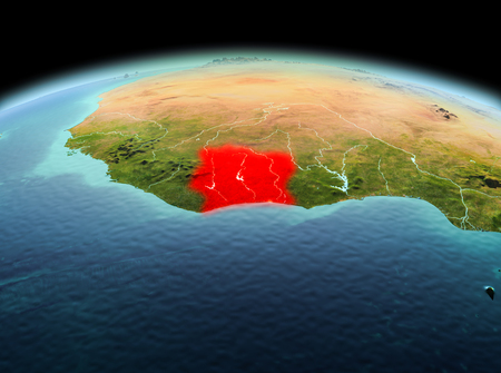 Morning above Ivory Coast highlighted in red on model of planet Earth in space. 3D illustration.の写真素材