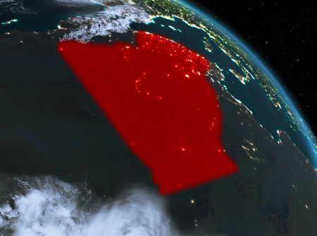 Night above Algeria highlighted in red on model of planet Earth in space. 3D illustration.の写真素材