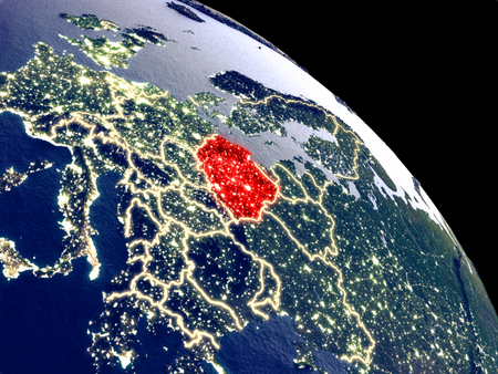 Poland at night from orbit. Plastic planet surface with visible city lights. 3D illustration.の写真素材