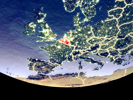 Satellite view of Belgium from space at night. Beautifully detailed plastic planet surface with visible city lights. 3D illustration.の写真素材