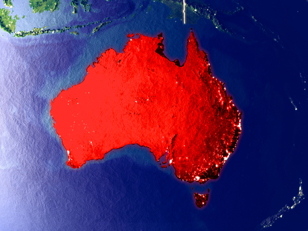 Australia from space on Earth at night. Very fine detail of the plastic planet surface with bright city lights. 3D illustration.の写真素材