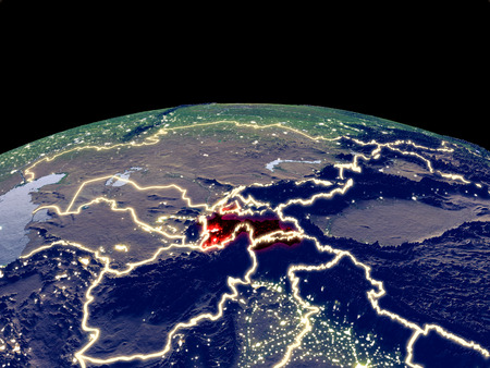 Tajikistan from space on planet Earth at night with bright city lights. Detailed plastic planet surface with real mountains. 3D illustration.の写真素材