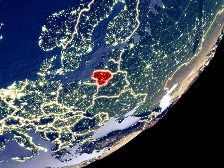 Lithuania from space on model of Earth at night. Very fine detail of the plastic planet surface and visible bright city lights. 3D illustration.の写真素材