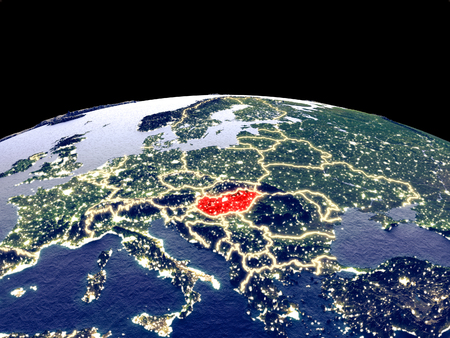 Hungary from space on planet Earth at night with bright city lights. Detailed plastic planet surface with real mountains. 3D illustration.の写真素材