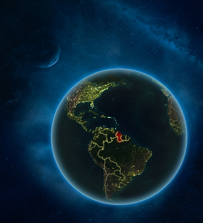 Guyana at night from space with Moon and Milky Way. Detailed planet Earth with city lights and visible country borders. 3D illustration.の写真素材