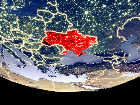 Satellite view of Ukraine from space at night. Beautifully detailed plastic planet surface with visible city lights. 3D illustration.の写真素材