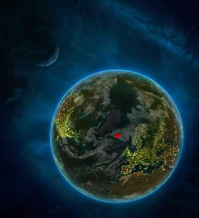Iceland from space on Earth at night surrounded by space with Moon and Milky Way. Detailed planet with city lights and clouds. 3D illustration.の写真素材