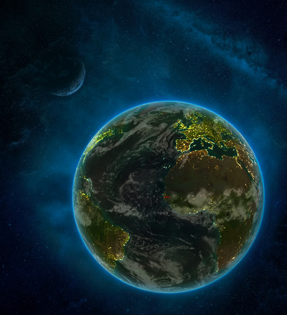Gambia from space on Earth at night surrounded by space with Moon and Milky Way. Detailed planet with city lights and clouds. 3D illustration.の写真素材