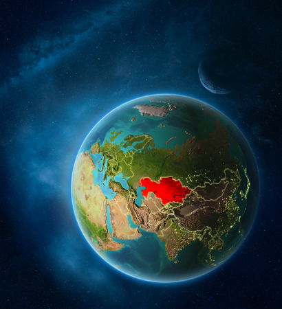 Planet Earth with highlighted Kazakhstan in space with Moon and Milky Way. Visible city lights and country borders. 3D illustration.の写真素材