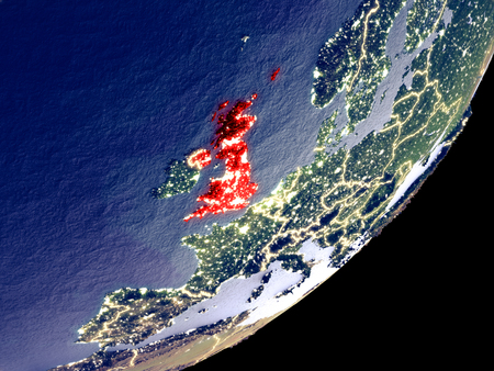 United Kingdom from space on model of Earth at night. Very fine detail of the plastic planet surface and visible bright city lights. 3D illustration.の写真素材