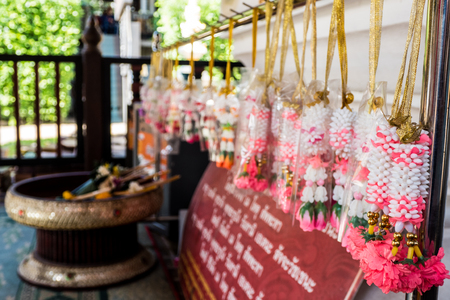 Thai style garland hang on handrail in the templeの写真素材