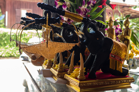 Souvenir of Black wooden elephants carry net basket in shopの写真素材