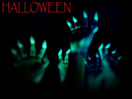An image for  showing a lot of zombie like hands outreaching in the darkness. 