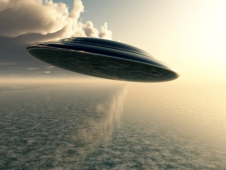 A Flying saucer hovering over a ocean.の写真素材