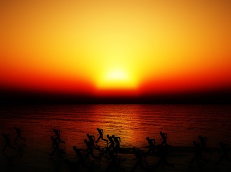 Lots of runners running on a beach coastlineの写真素材