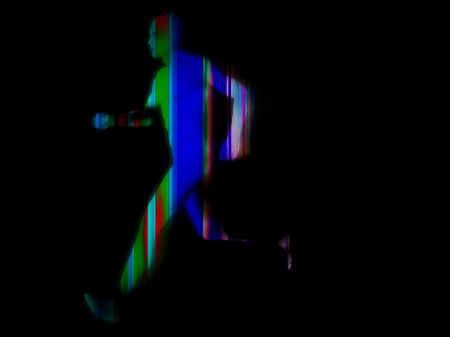 Man running against a lined background.の写真素材