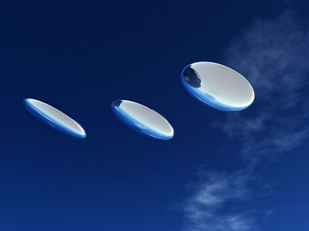Three UFO's that are flying in formation in the sky.の写真素材