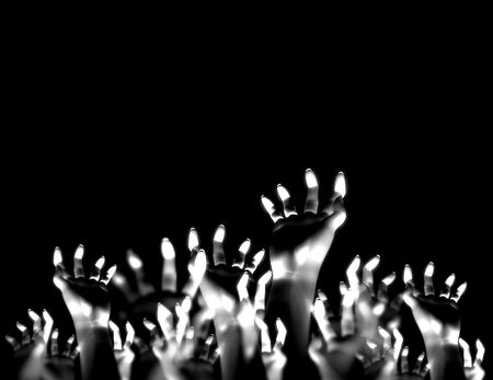 A crowed of hands reaching into the air.の写真素材