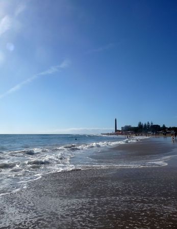 A view of Maspalomas beach with the lighthouse in the distance.の写真素材