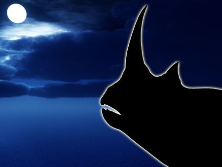 Silhouette of a Rhino with a nighttime background.の写真素材