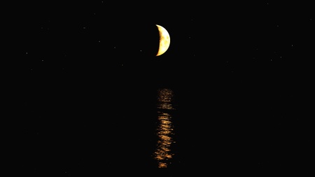 The sea with the moon in the background.の写真素材