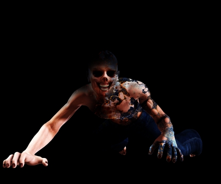 Horribly decomposing zombie that is crawling on the ground の写真素材