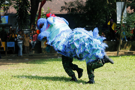 Nganjuk, East Java, Indonesia, 04/19/2014: Do the Lion Dance by Indonesian Armed Forces in the square during the anniversary of the city Nganjuk.のeditorial素材