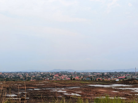 A vast, undeveloped plot of land overlooks a sprawling African city, hinting at urban expansion and future construction.の写真素材