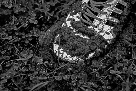 Old shoe stuck in mudの写真素材
