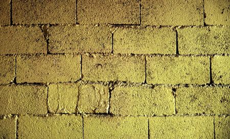 Brick wall texture in yellow toneの写真素材